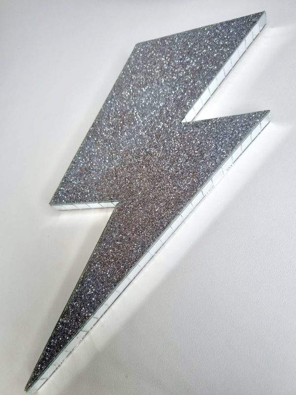 Silver glitter acry;ic lightning bolt wall art.