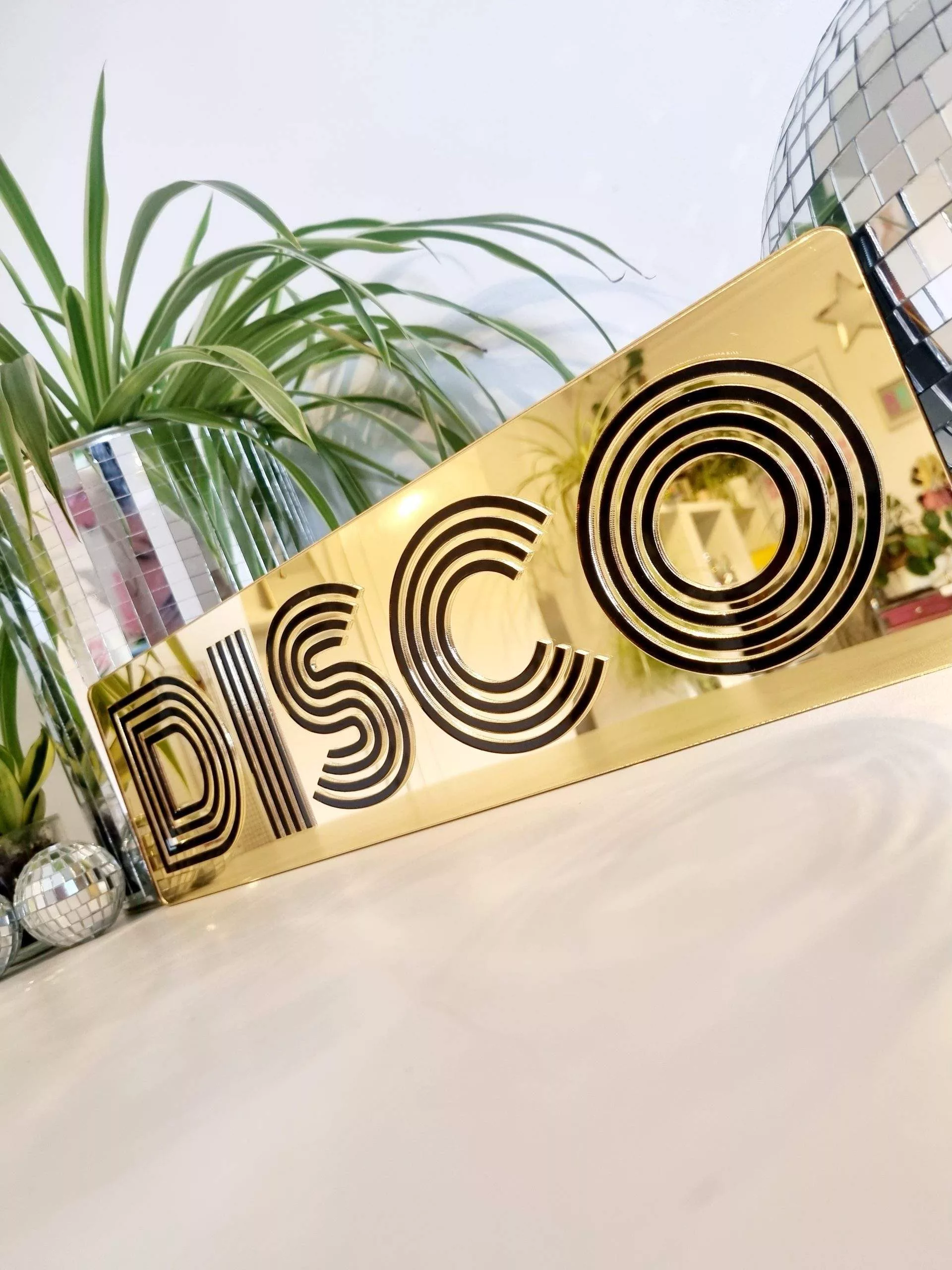 Gold and black disco mirror word art sign.