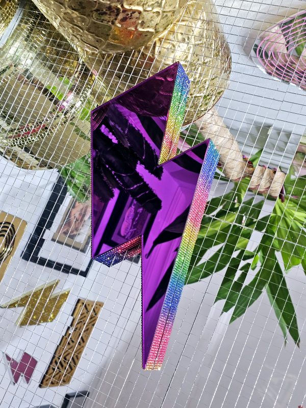 A purple mirror in the with rainbow rhinestone edging.