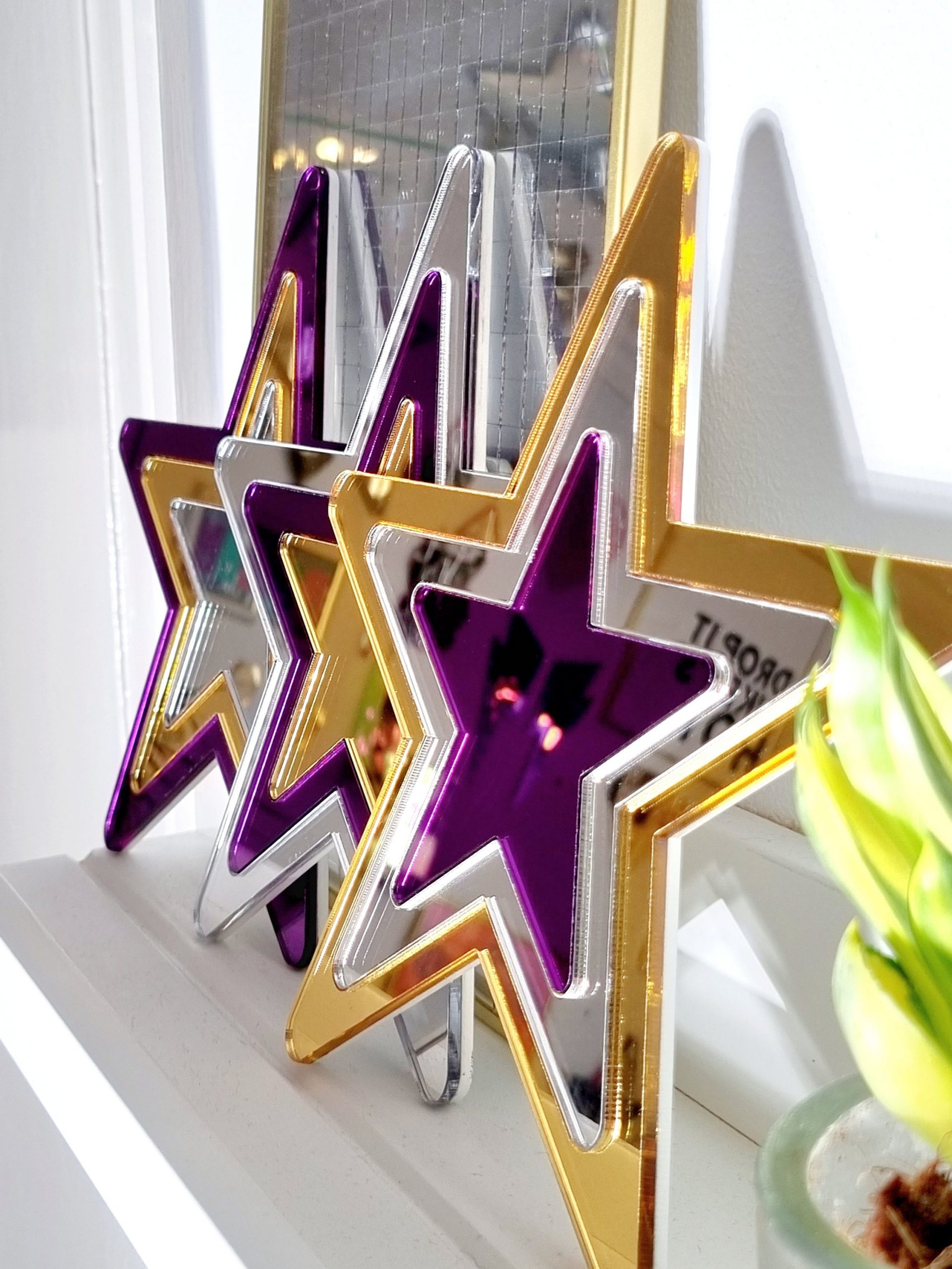 Set of mirror stars made from gold, purple and silver acrylic.