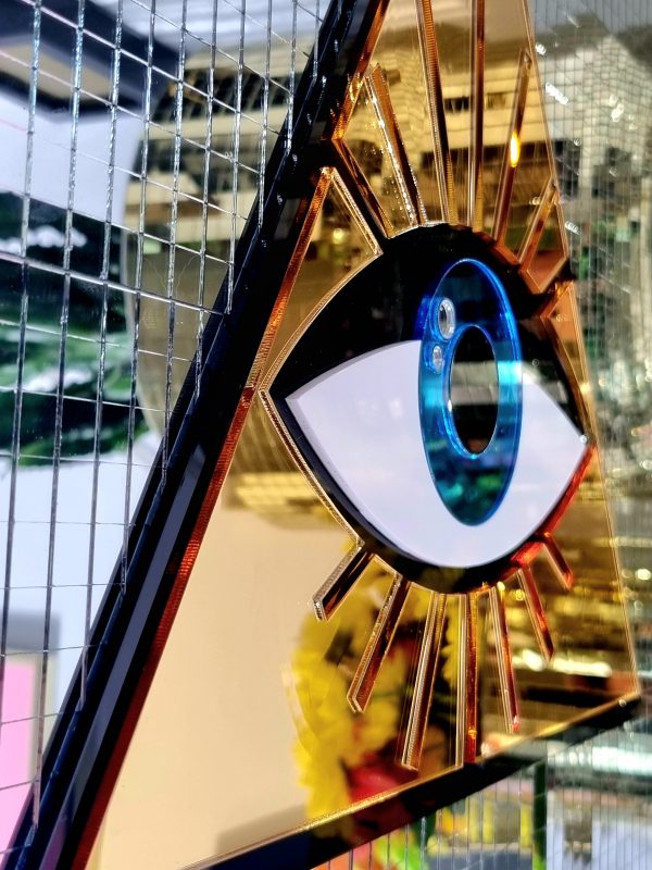 A handmade mirror in an All Seeing Eye design.