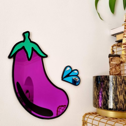PURPLE AND BLACK MIRROR IN THE SHAPE OF AN AUBERGINE EMOJI.