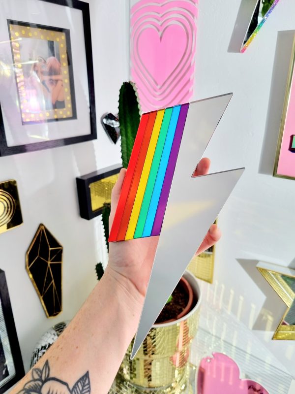 Mirrors in the shape of lightning bolts. They have pieces of gold and silver mirror, along with rainbow mirror pieces to create a spectrum effect.