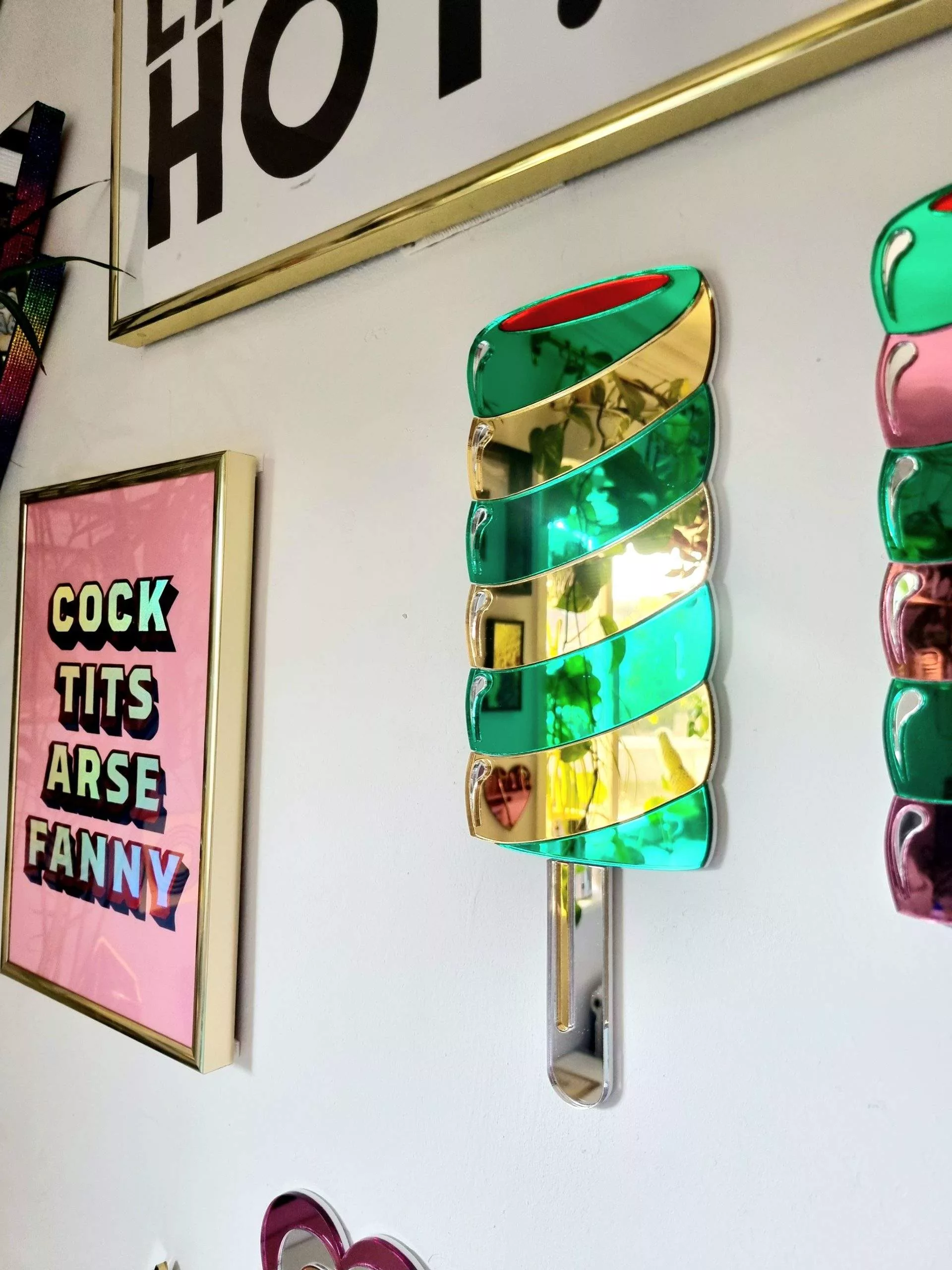 Hanamde Twister lolly mirror in gold and green.