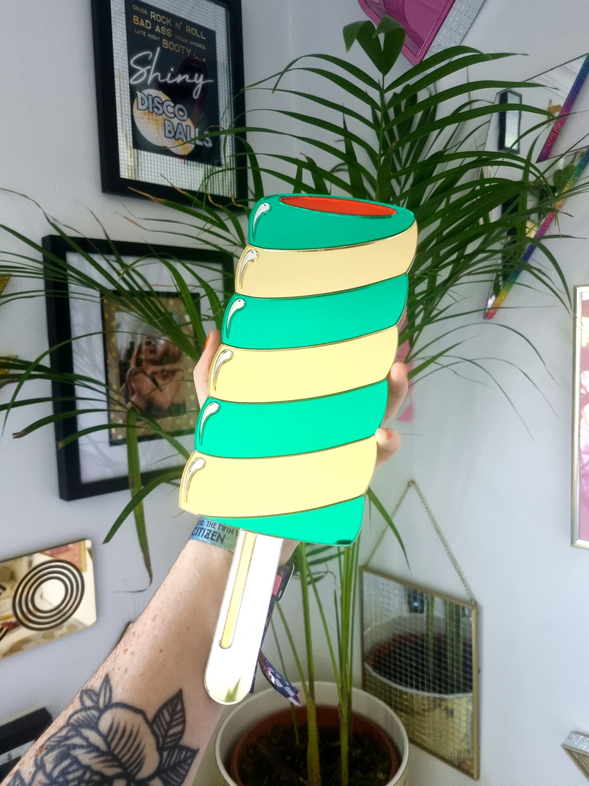 Hanamde Twister lolly mirror in gold and green.
