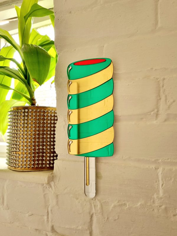 Hanamde Twister lolly mirror in gold and green.