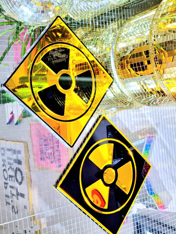 A picture showing two mirrors in the design of the radioactive symbol