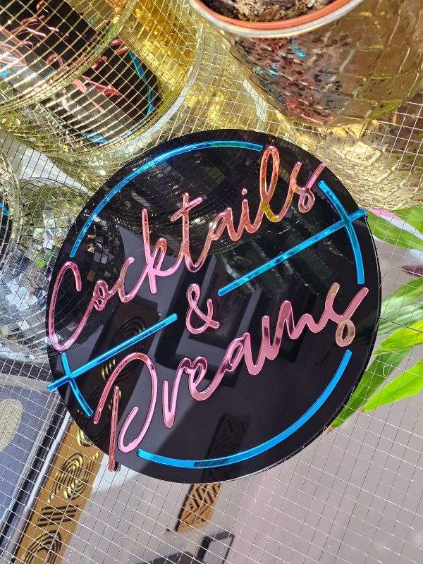 Cocktails and Dreams mirror wall art. A piece inspired by the film cocktail, made with black gloss acryilic and blue and pink mirrored lettering.