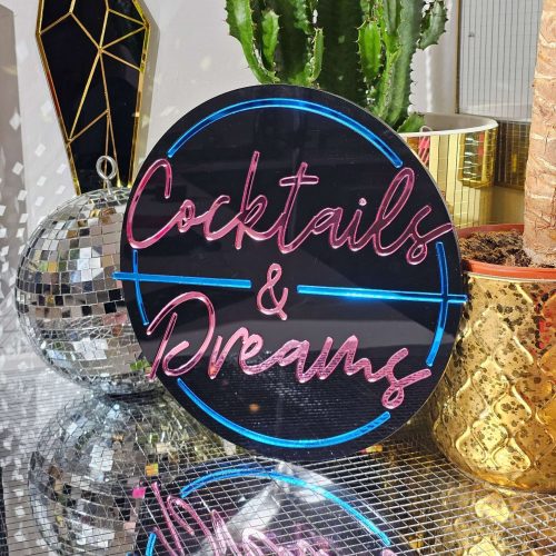 Cocktails and Dreams mirror wall art. A piece inspired by the film cocktail, made with black gloss acryilic and blue and pink mirrored lettering.