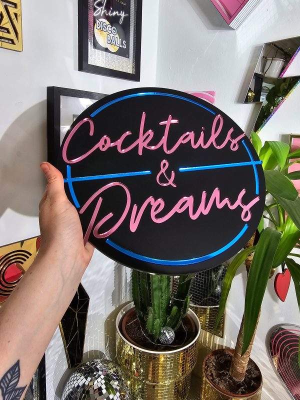 Cocktails and Dreams mirror wall art. A piece inspired by the film cocktail, made with black gloss acryilic and blue and pink mirrored lettering.