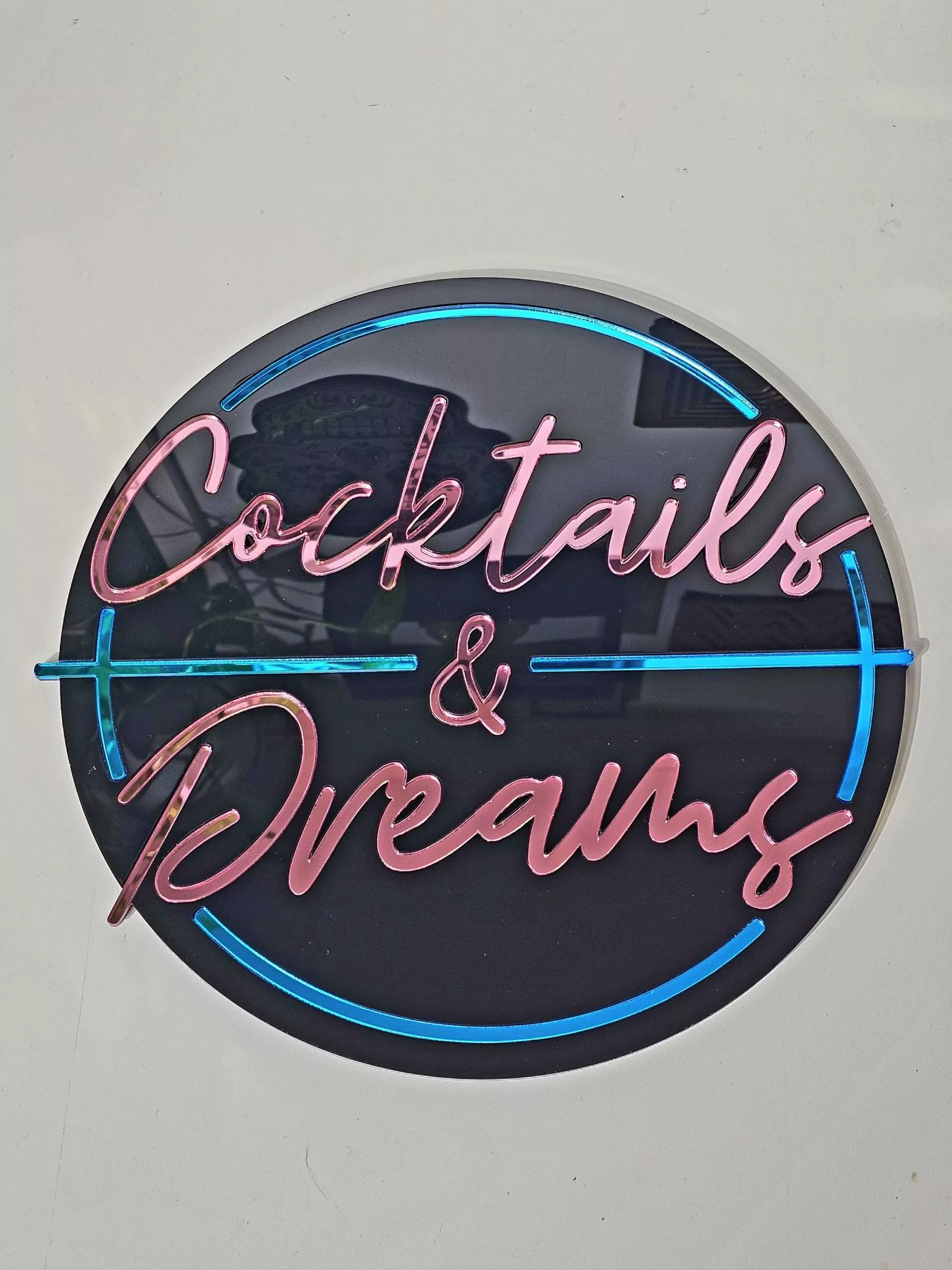 Cocktails and Dreams mirror wall art. A piece inspired by the film cocktail, made with black gloss acryilic and blue and pink mirrored lettering.