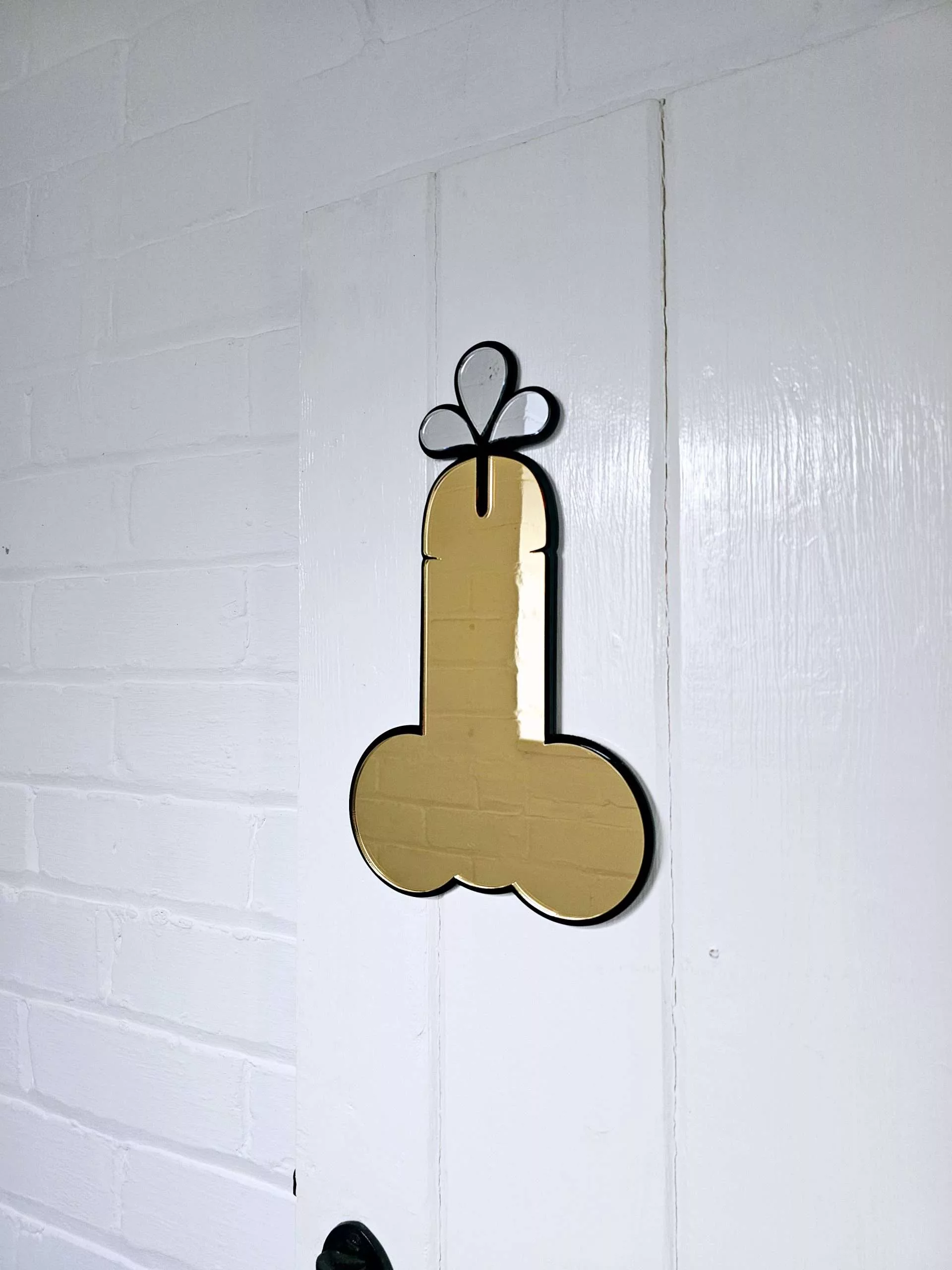 A handmade mirror in the shape of a penis.