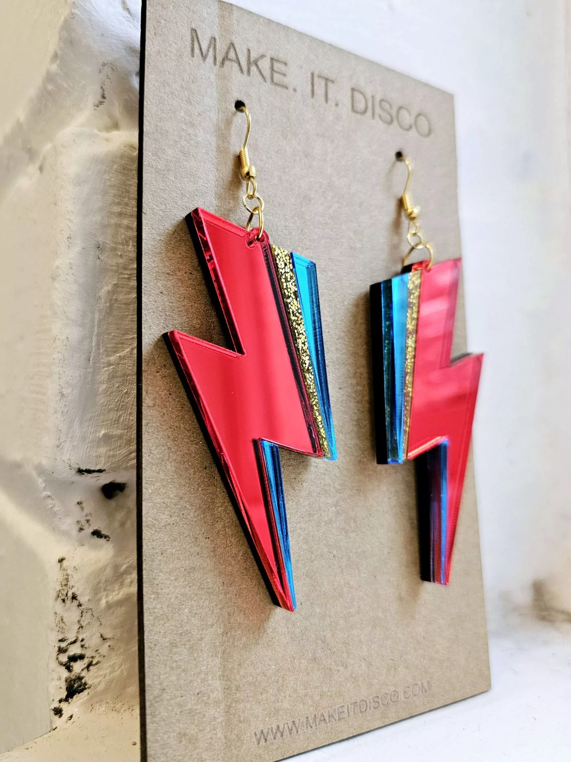 A pair of handmade earrings in the style of the lightning bolt David Bowie wore across his face.