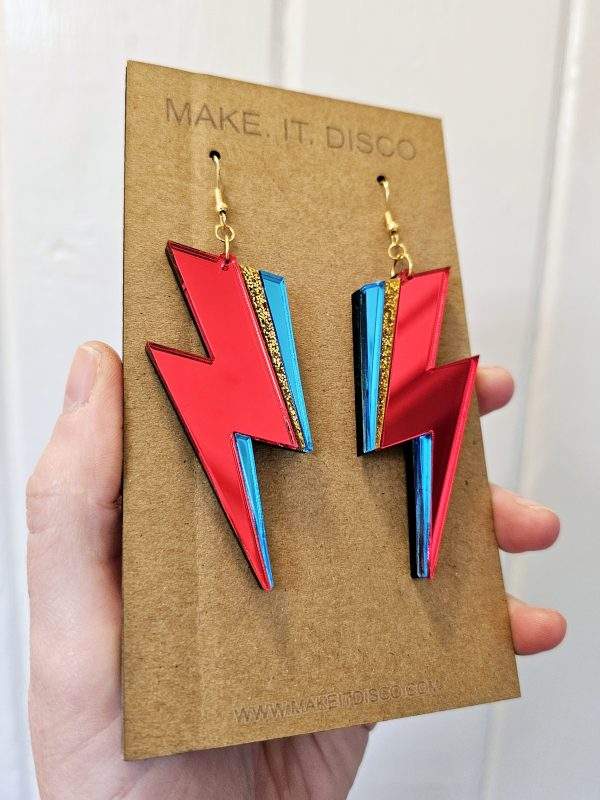 A pair of handmade earrings in the style of the lightning bolt David Bowie wore across his face.