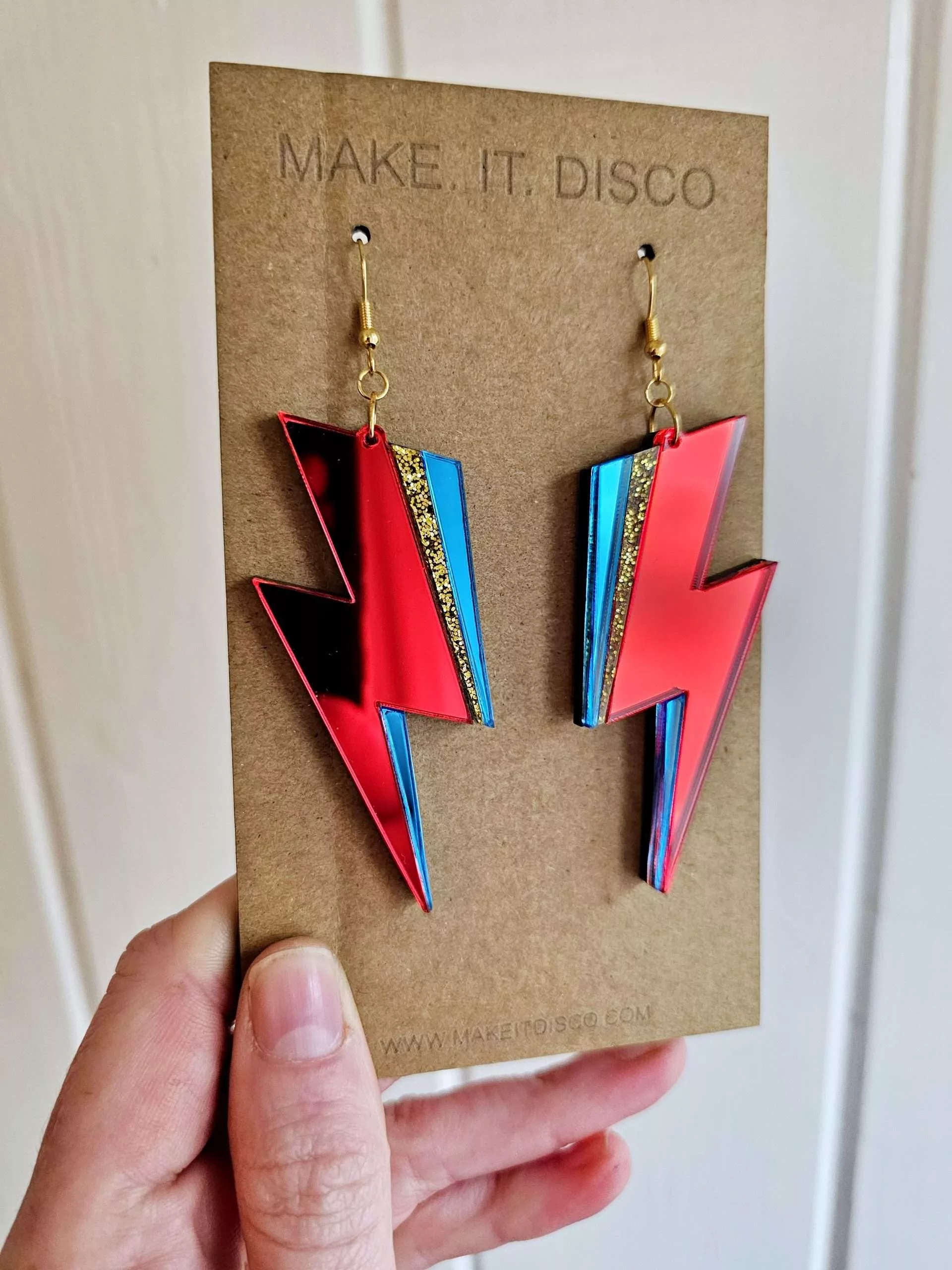 A pair of handmade earrings in the style of the lightning bolt David Bowie wore across his face.