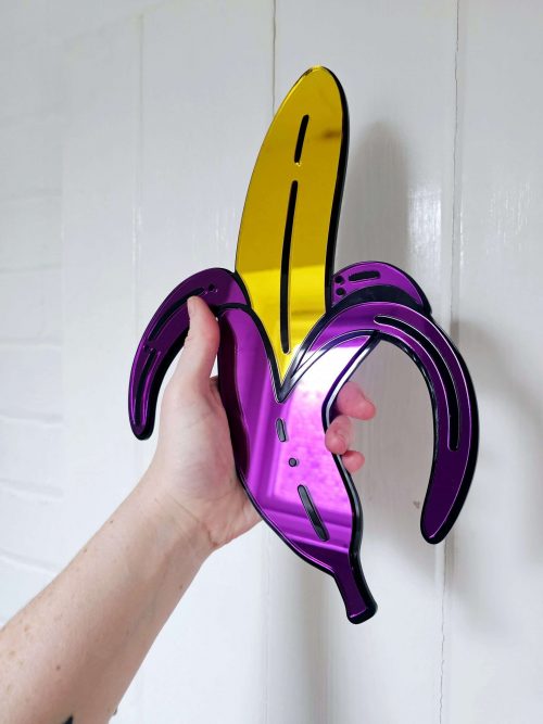 A handmade mirror in the shape of a banana.