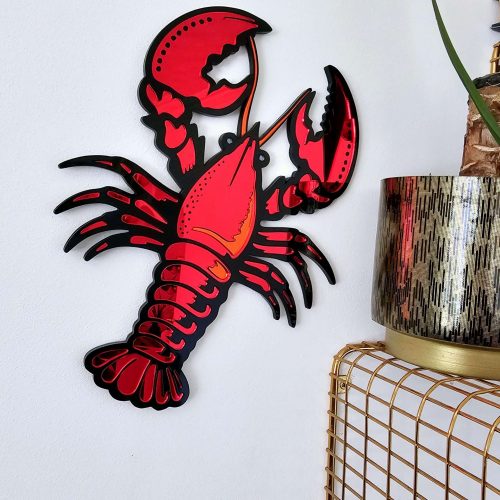 A handmade piece or mirror wall art in the shape of a lobster.