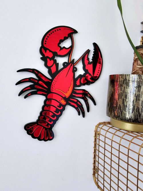 A handmade piece or mirror wall art in the shape of a lobster.