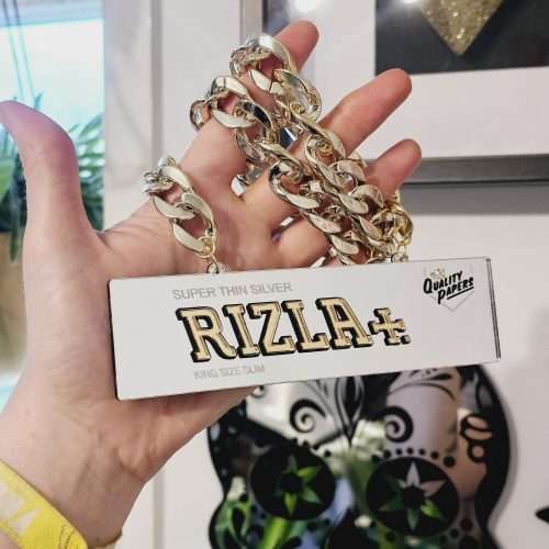 A handmade necklace in the shape of a silver Rizla packet.