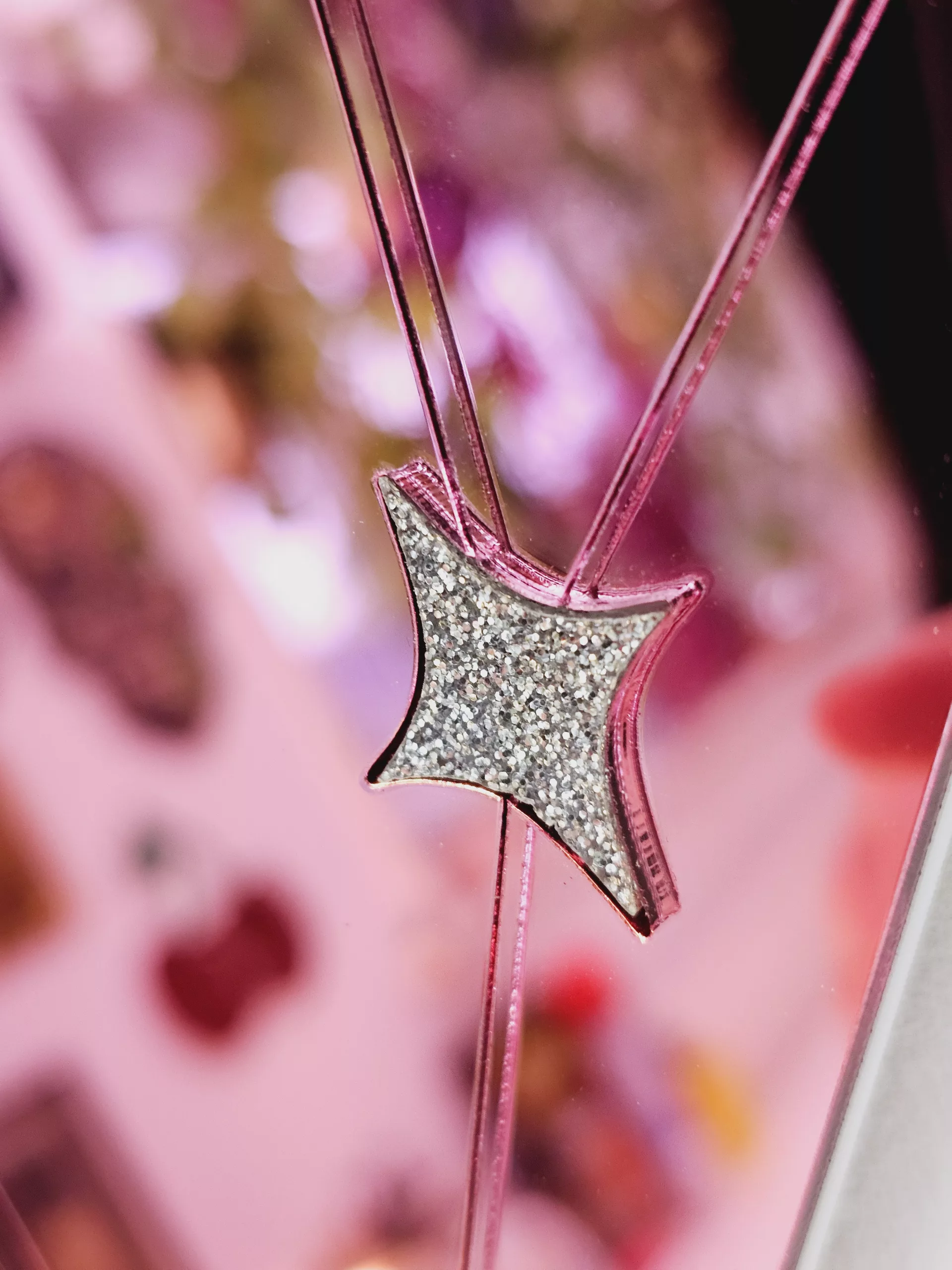 A handmade mirror on the shape of a sword piercing a heart. Made with gold, rose gold, pink and silver mirror with gem accents.