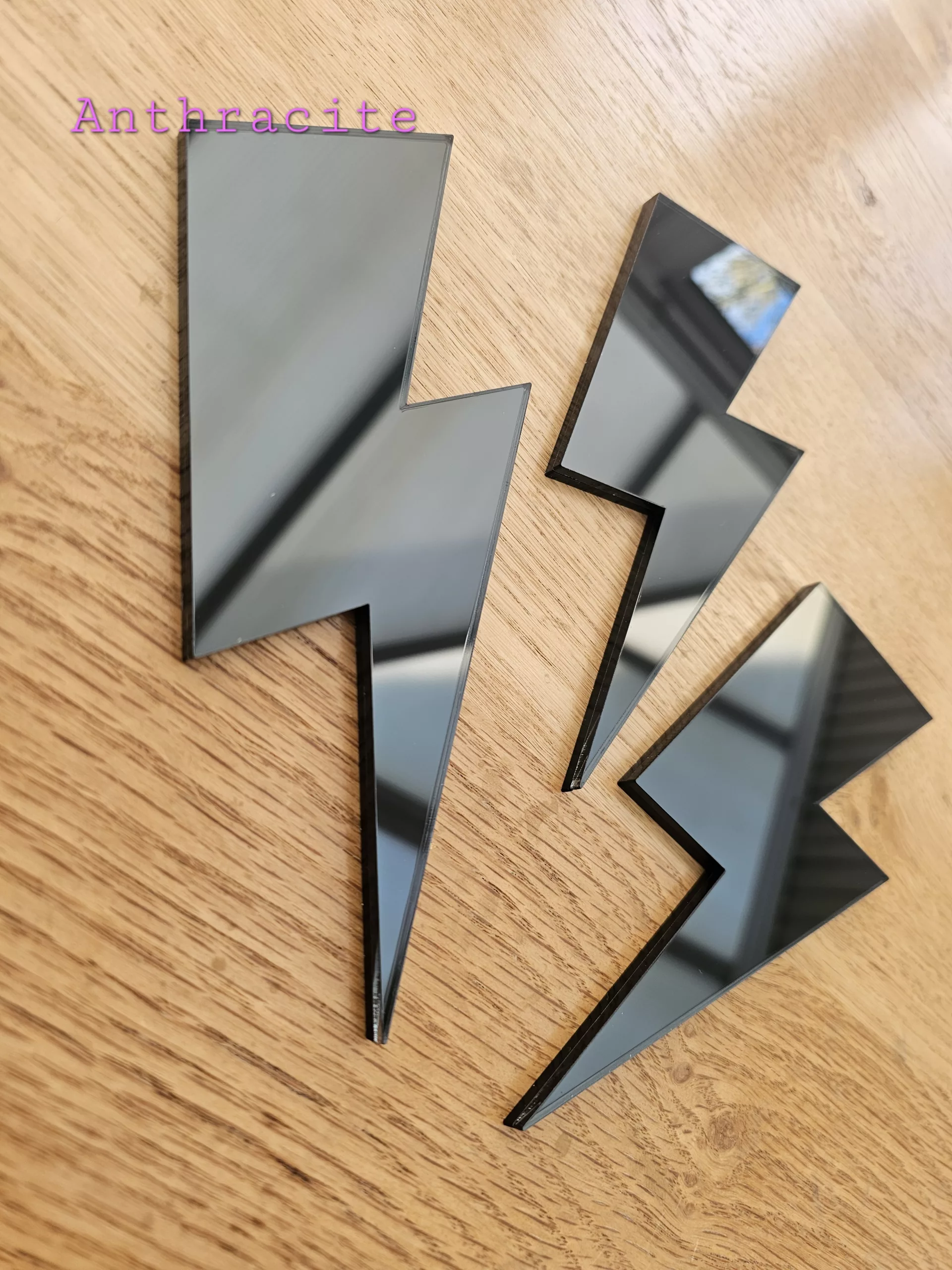 A set of 3 mirrors in the shape of a lightning bolt, in a variety of colours.