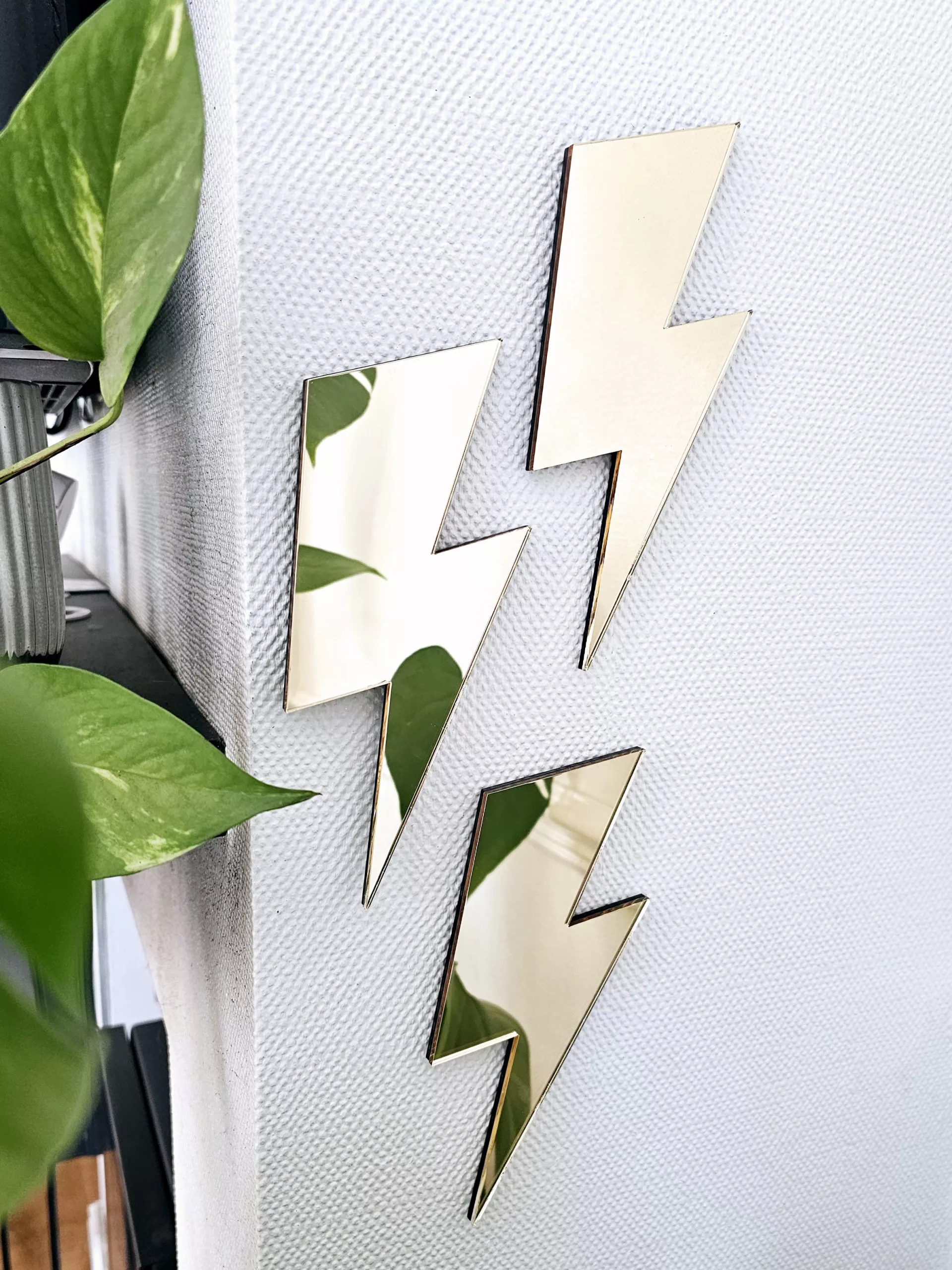 A set of 3 mirrors in the shape of a lightning bolt, in a variety of colours.