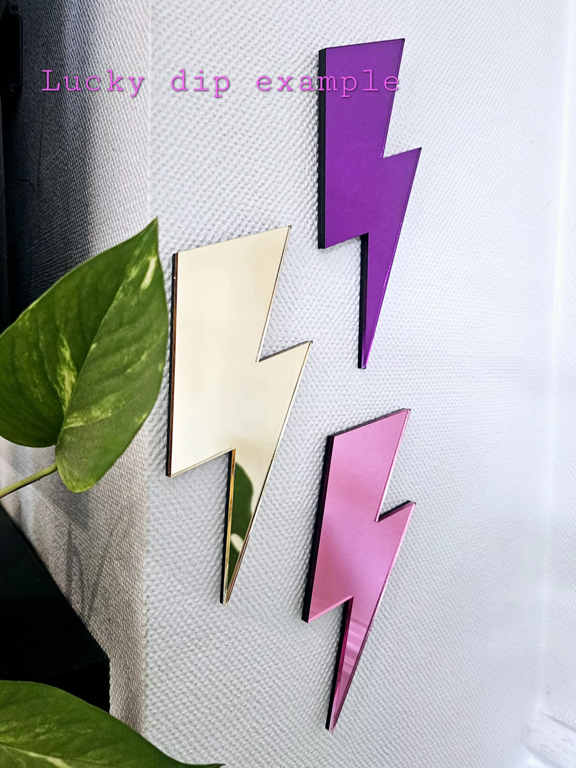 A set of 3 mirrors in the shape of a lightning bolt, in a variety of colours.