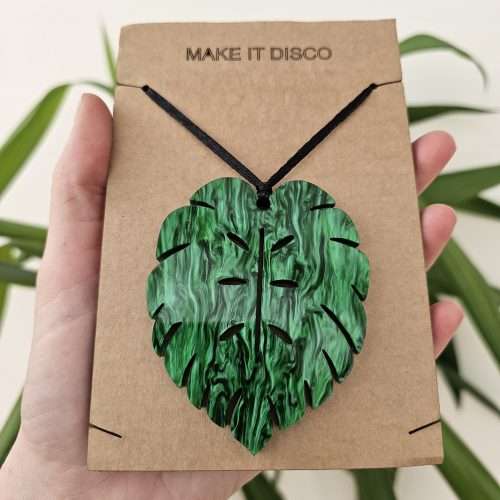 A plant charm or Christmas tree decoration in the shape of a Monstera Leaf.