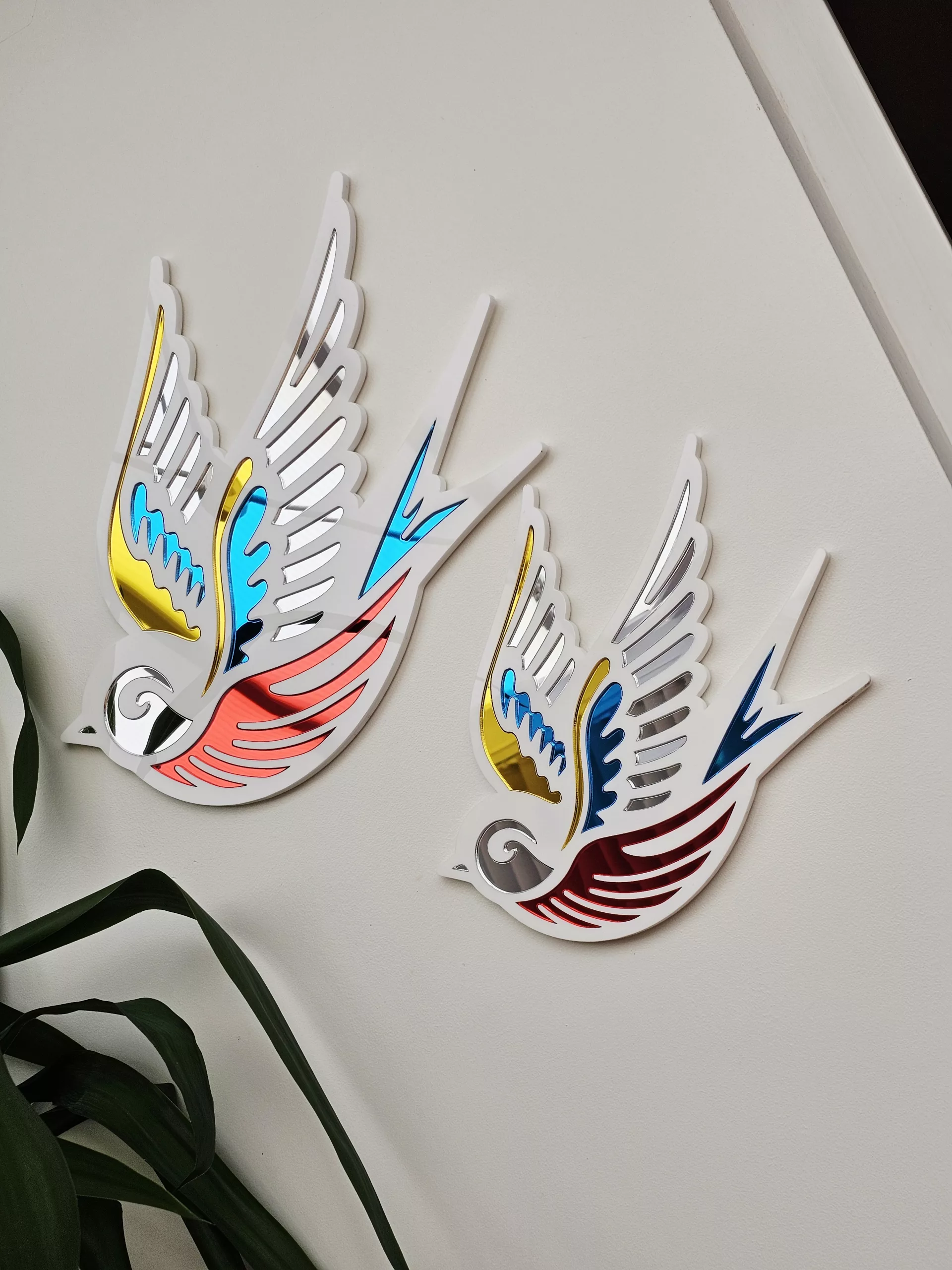 A mirror in the shape of a swallow, made in an old school tattoo style.
