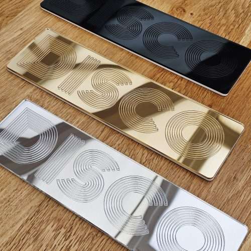 A picture of a disco wall art sign, made with mirror and retro font.