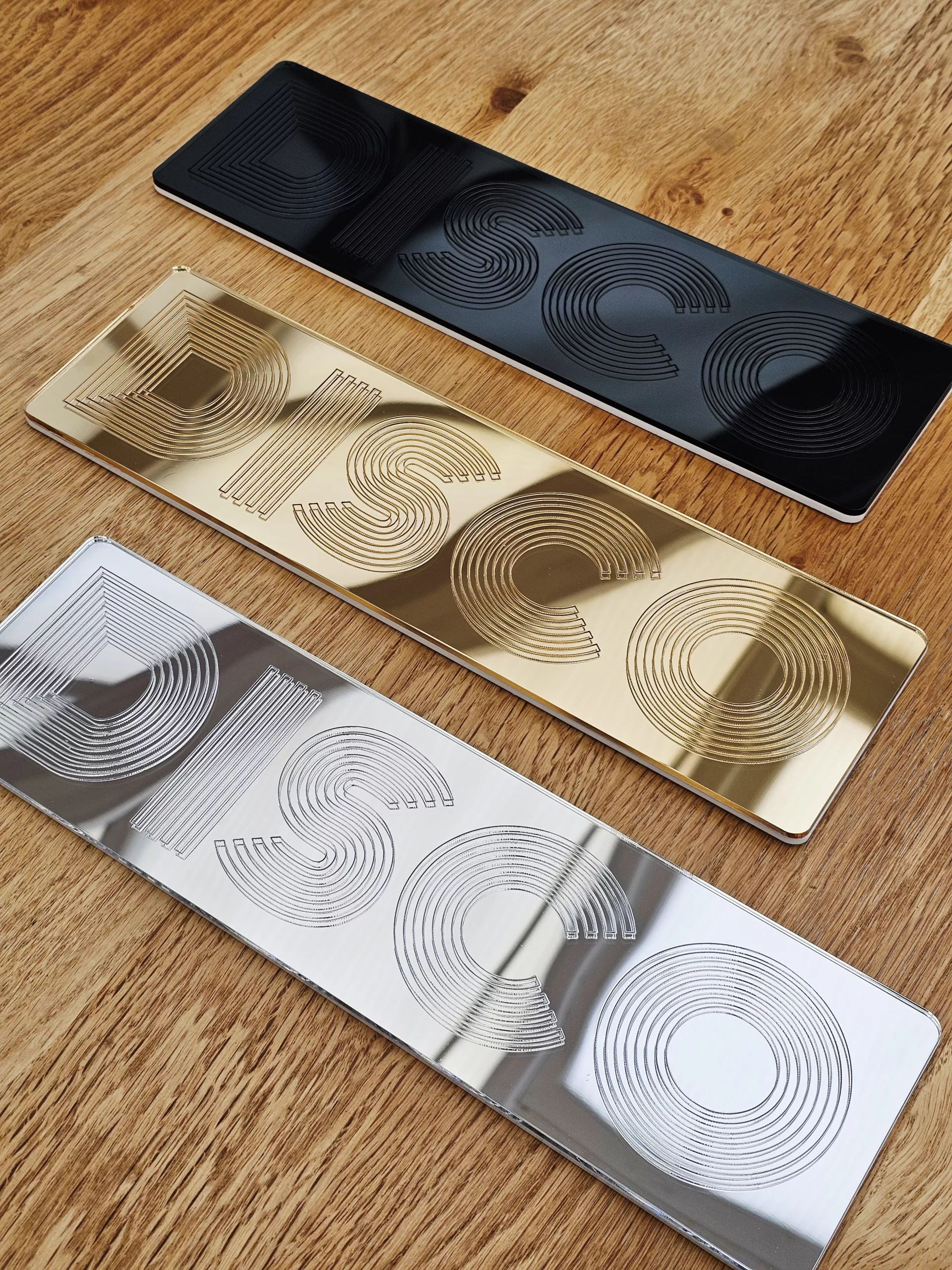 A picture of a disco wall art sign, made with mirror and retro font.