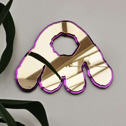 A mirror in the shape of the iconic Monster Munch snack. Made with gold mirror and purple outline.
