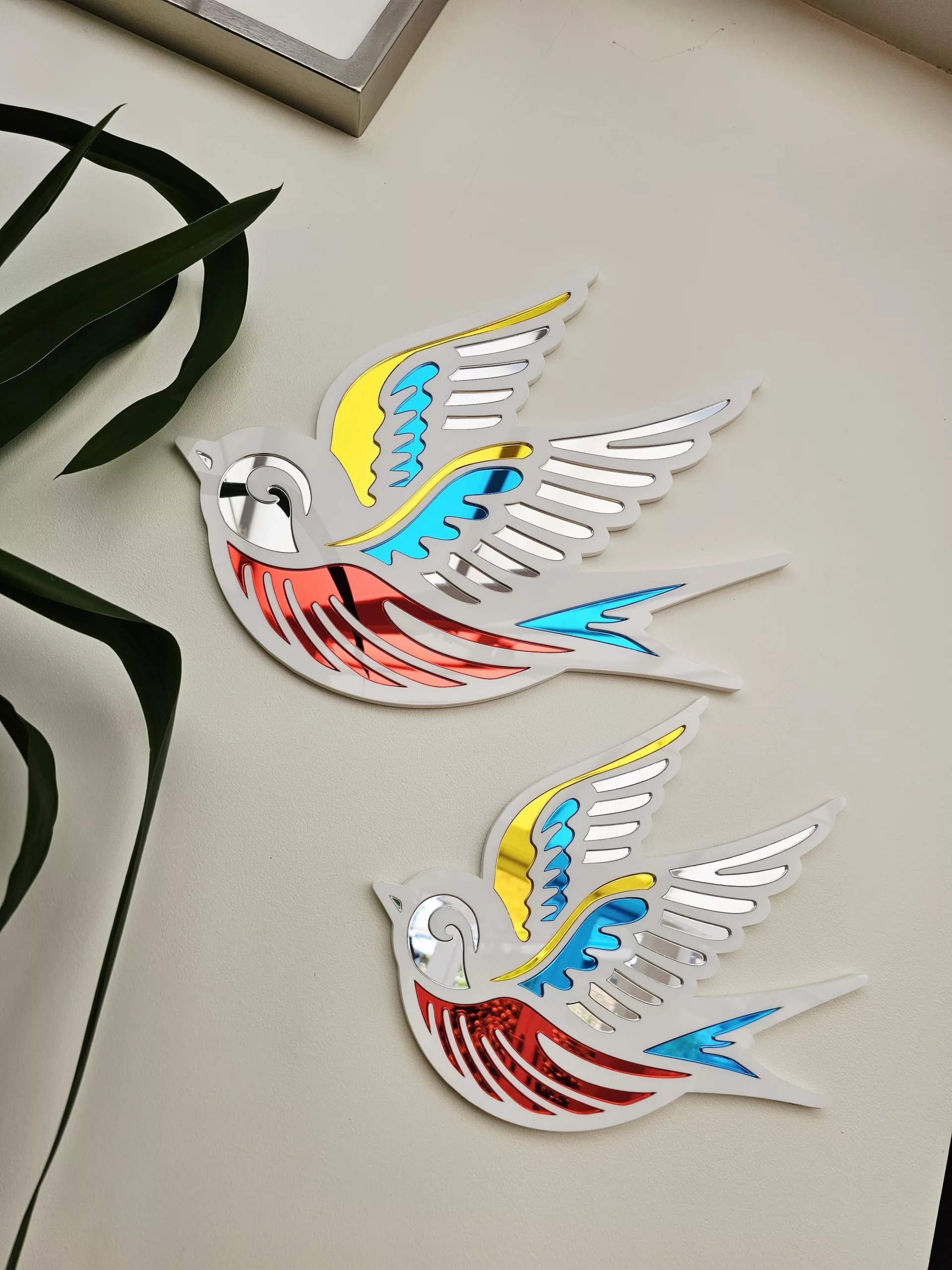 A mirror in the shape of a swallow, made in an old school tattoo style.