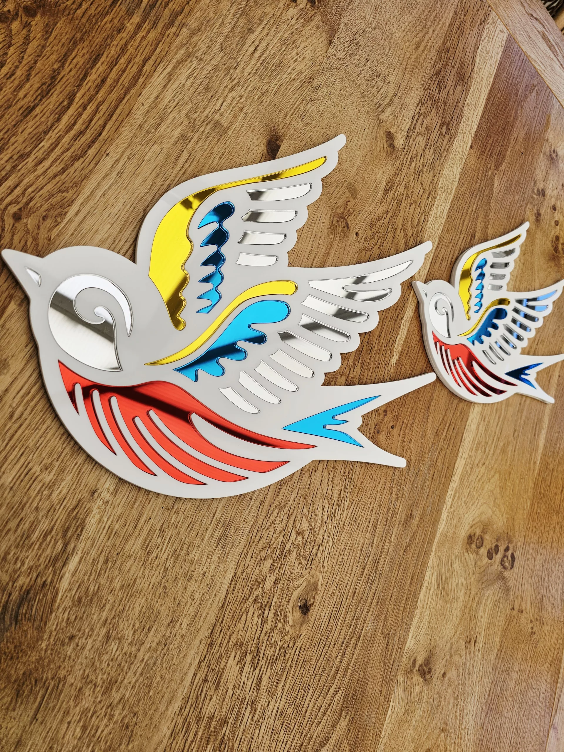 A mirror in the shape of a swallow, made in an old school tattoo style.