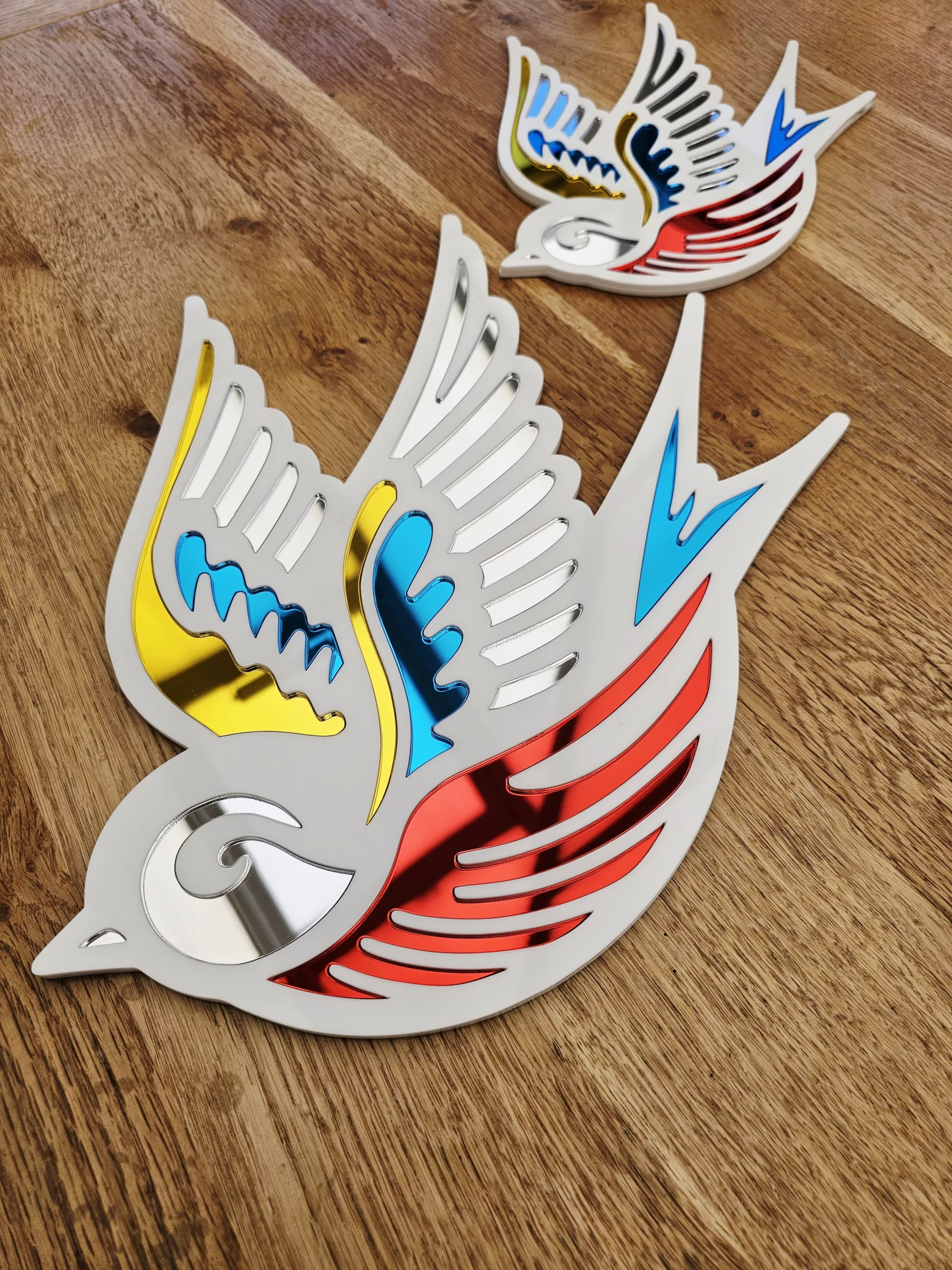 A mirror in the shape of a swallow, made in an old school tattoo style.