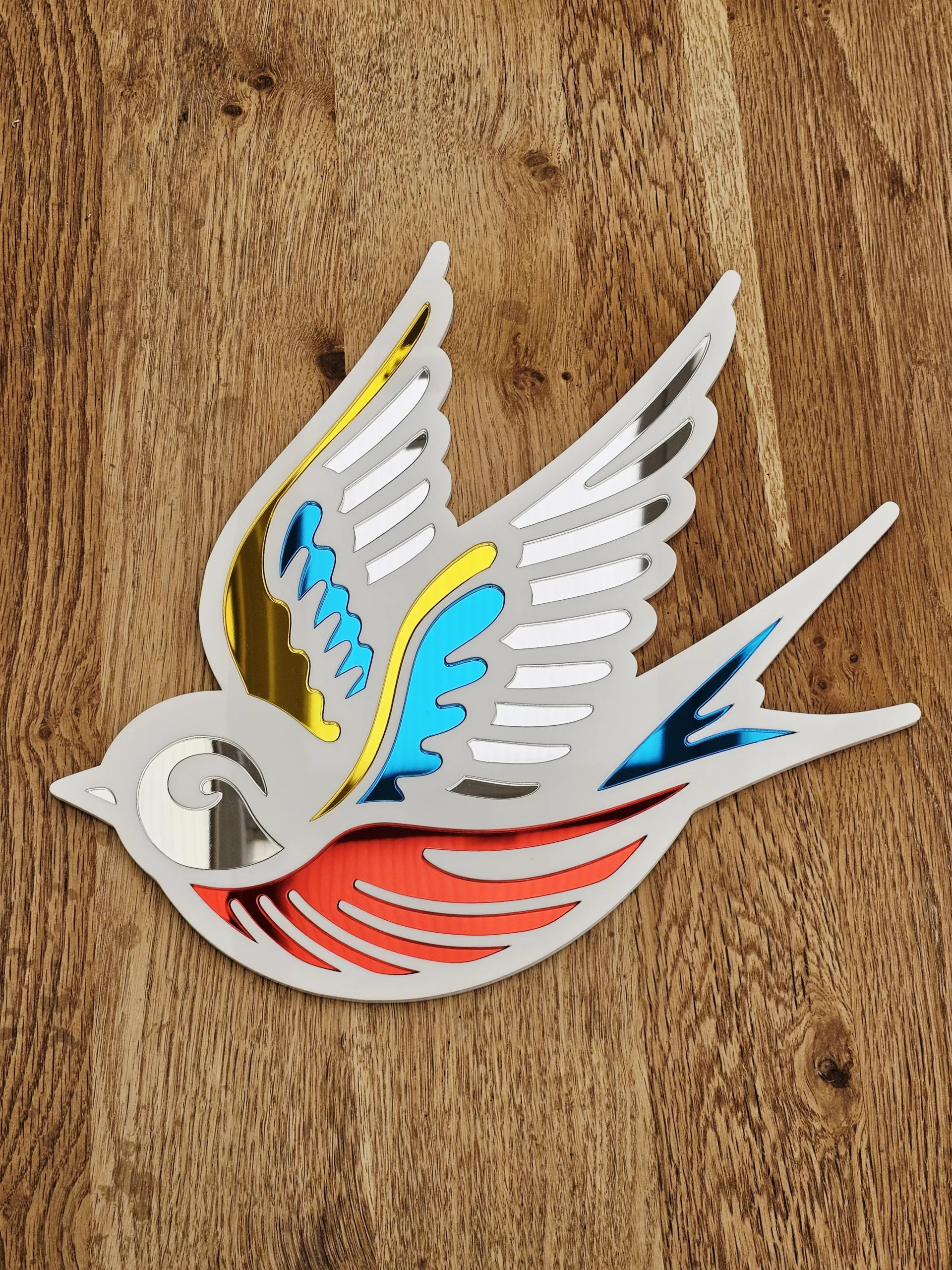 A mirror in the shape of a swallow, made in an old school tattoo style.