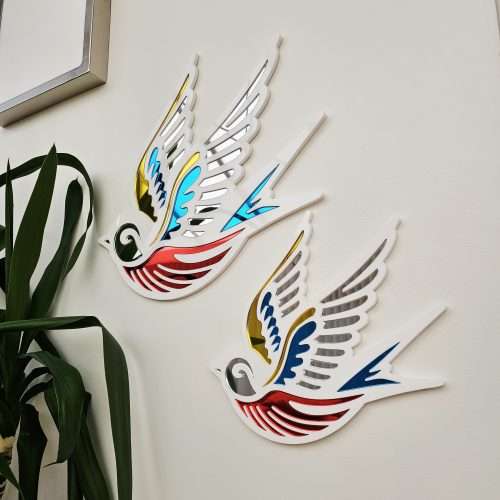 A mirror in the shape of a swallow, made in an old school tattoo style.