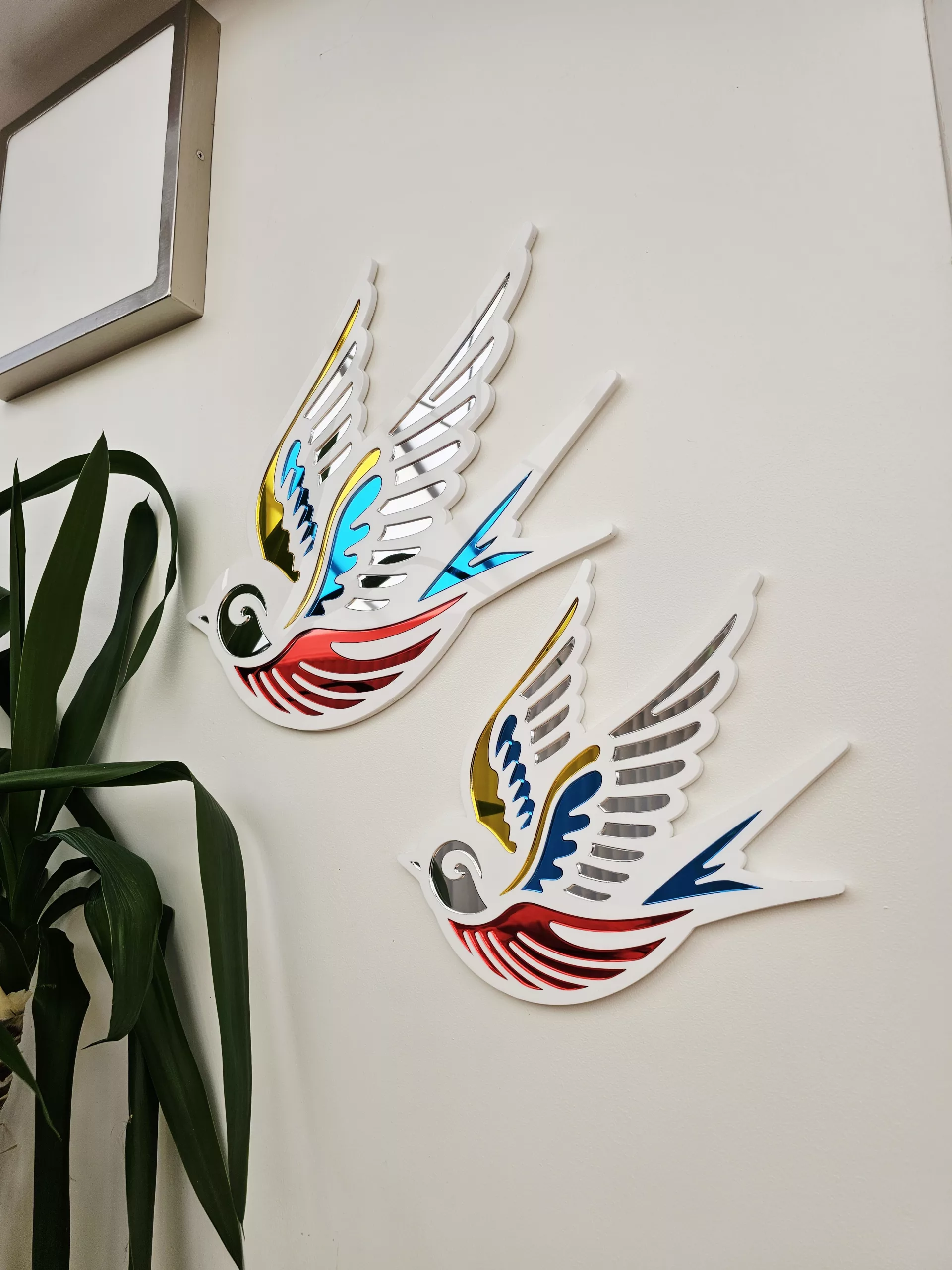 A mirror in the shape of a swallow, made in an old school tattoo style.