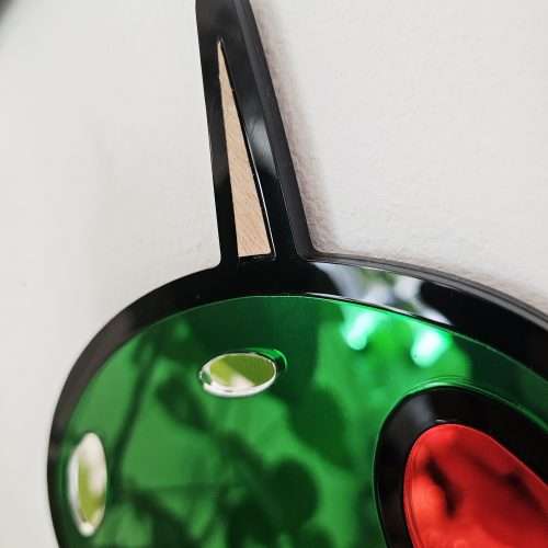 Mirrored wall art in the shape of olives on a cocktail stick.