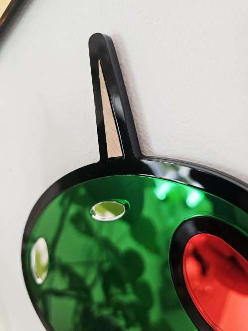 Mirrored wall art in the shape of olives on a cocktail stick.