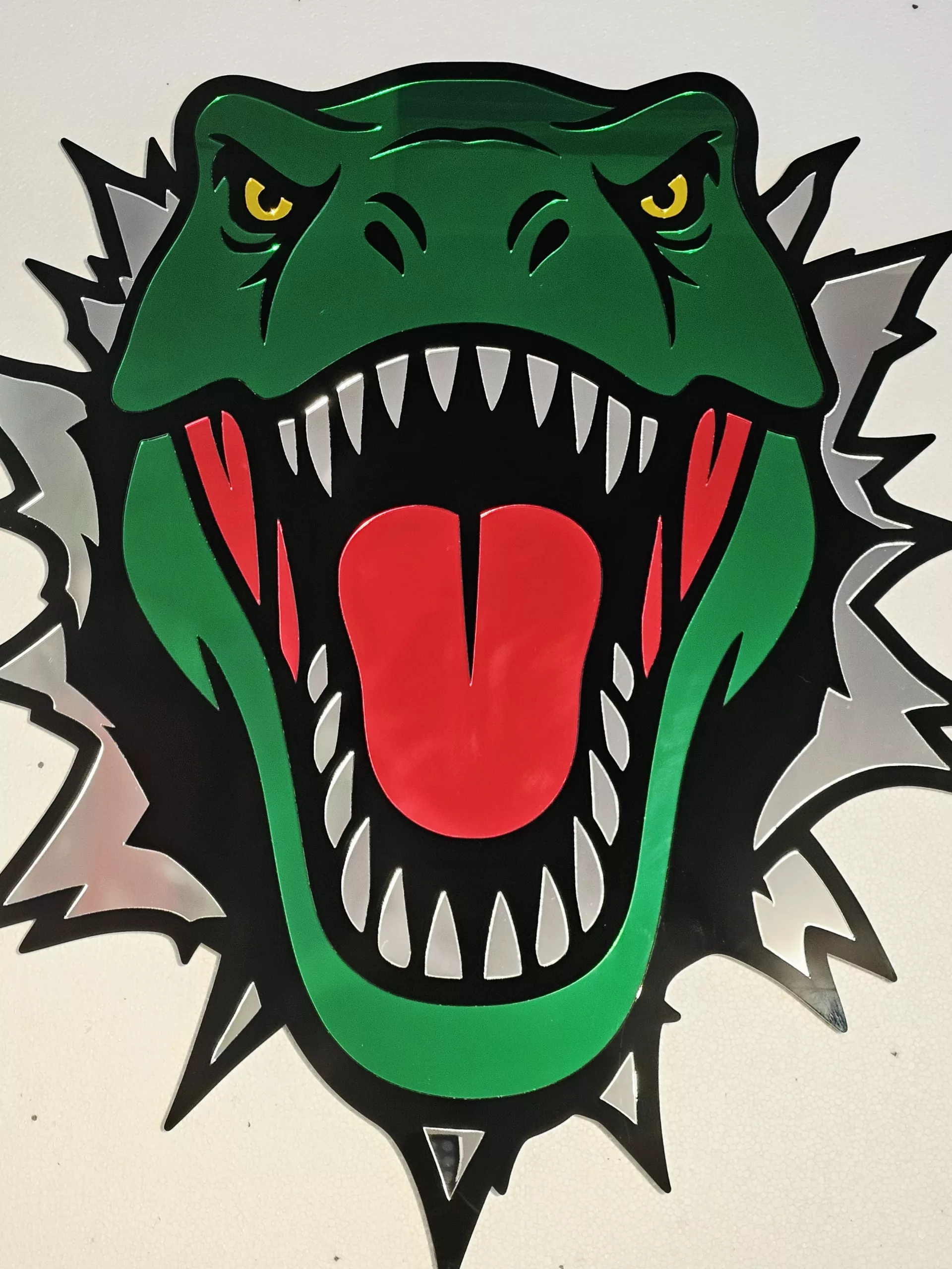 Coloured mirrored acrylic wall art in the shape of a T-Rex dinosaur